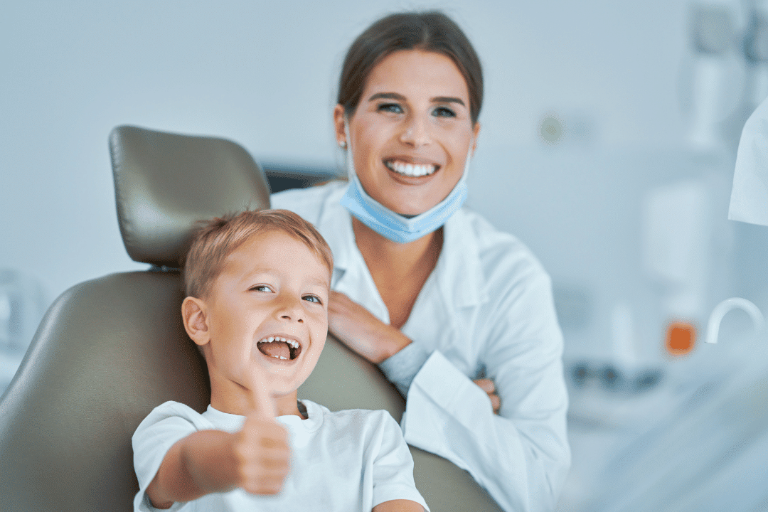 Pediatric Root Canal Vs. Tooth Extraction Smiling Pediatric Dentist And Young Patient