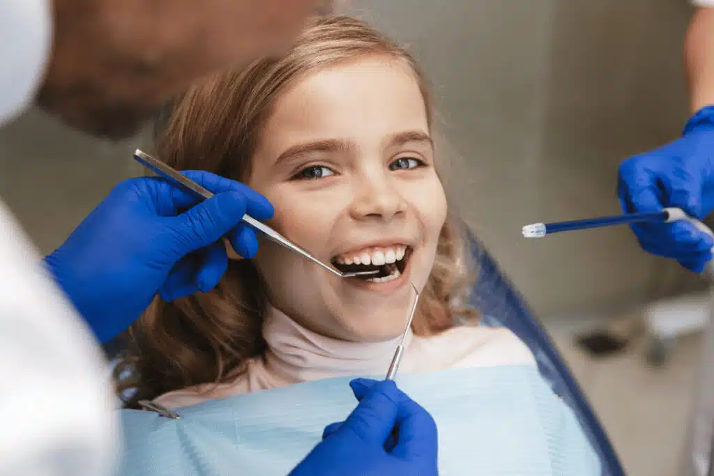 Beyond Cavities: How Pediatric Oral Health Affects Your Child’s Airway, Sleep &Amp; Behavior Child Smiling During Dental Checkup