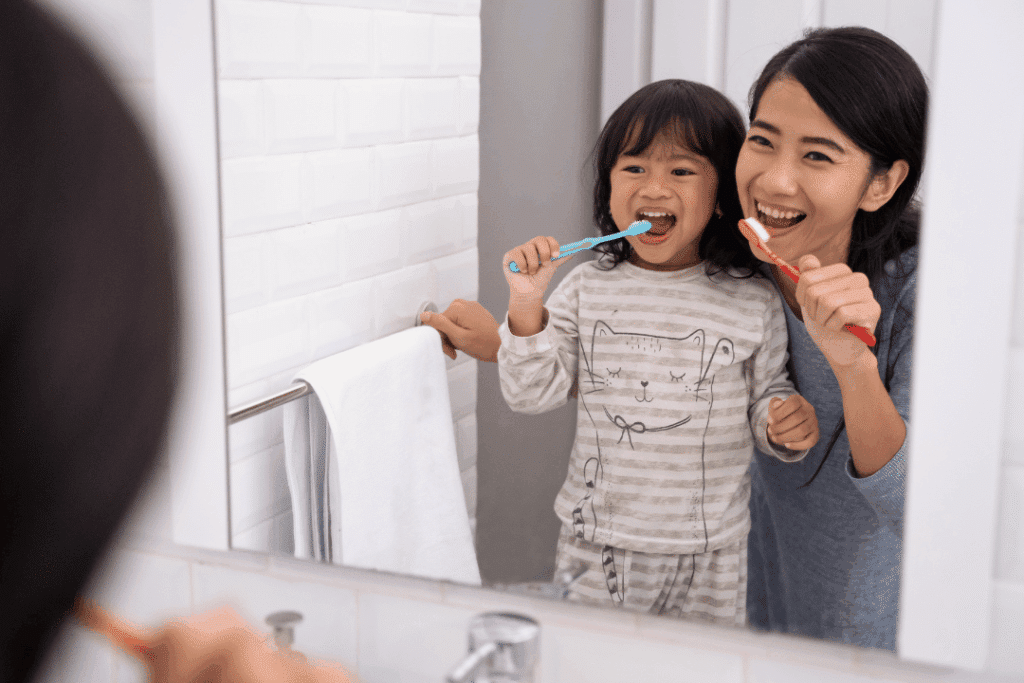 Parent Helping Child Use Safe Toothpaste For Kids During Their Morning Routine