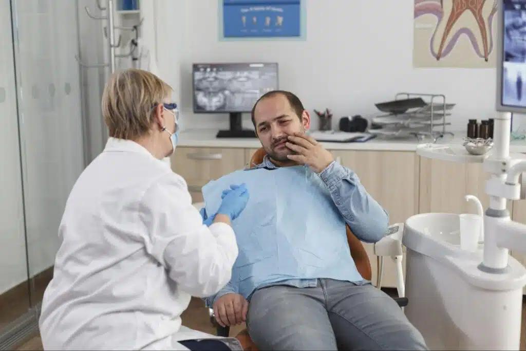 Orthodontist Explaining Treatment To Patient With Toothache