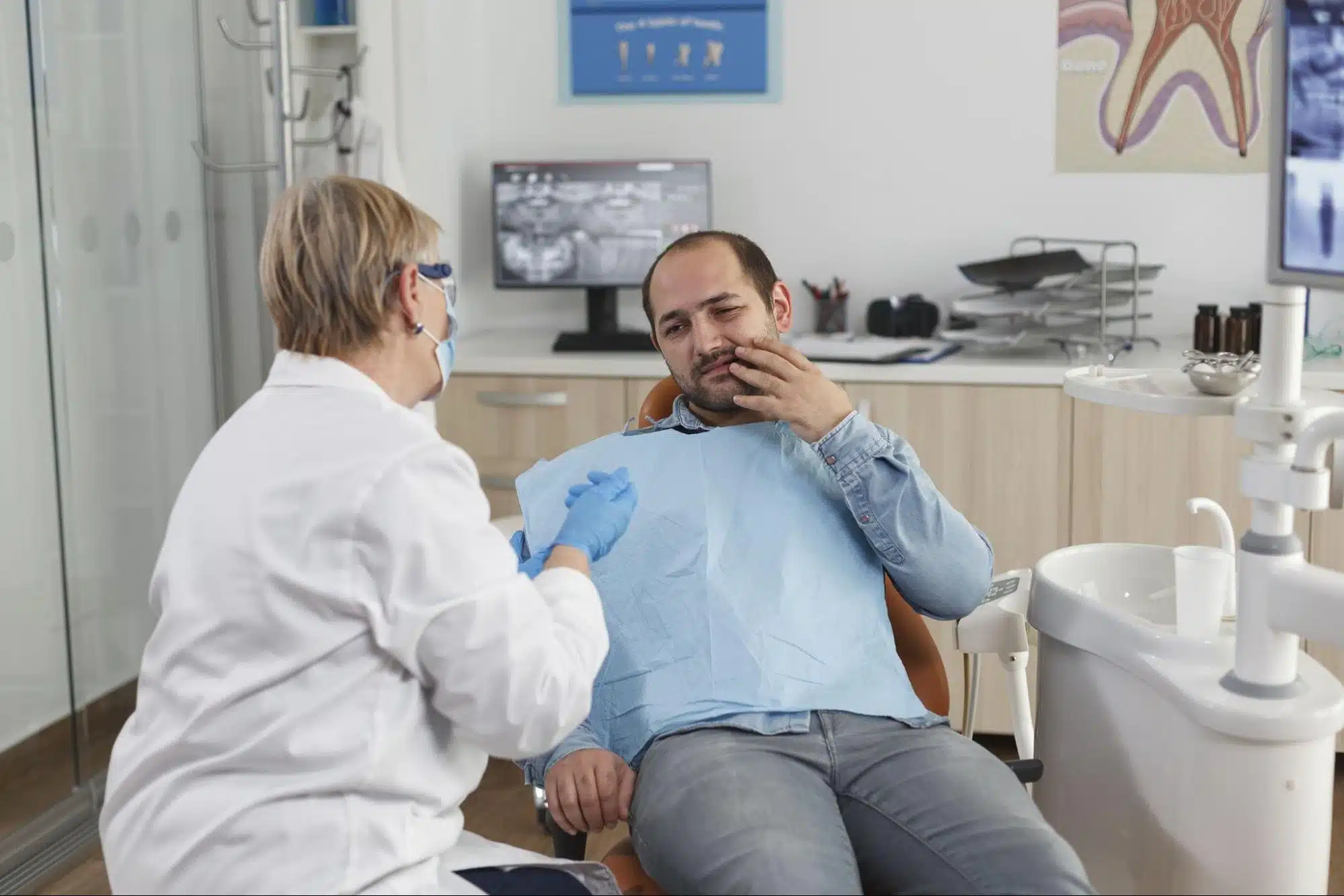 Orthodontist Explaining Treatment To Patient With Toothache